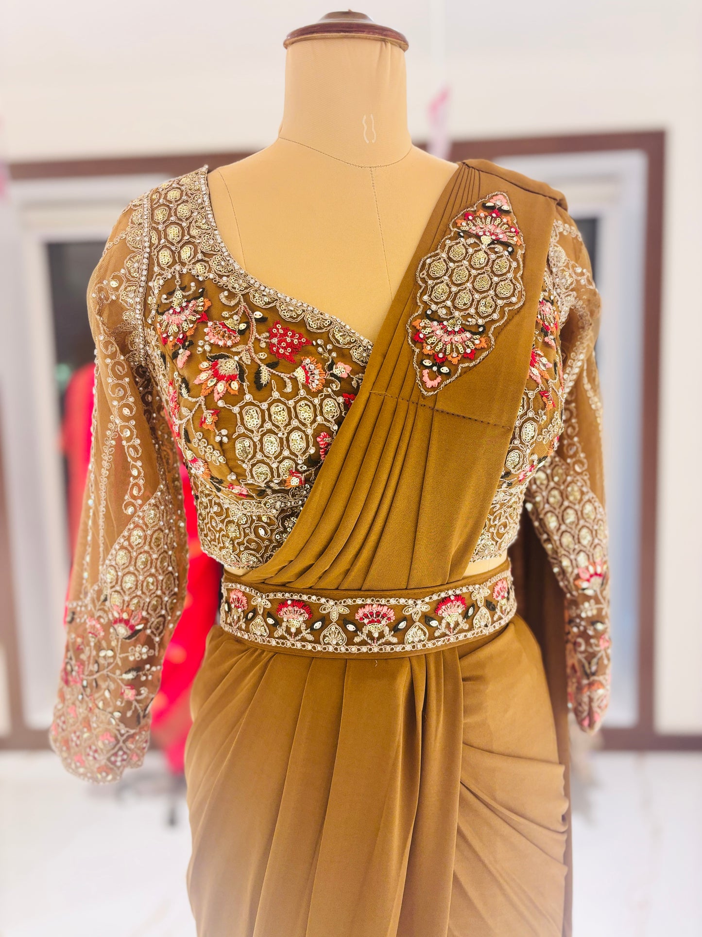 Gold ready made Saree with embroidered blouse.