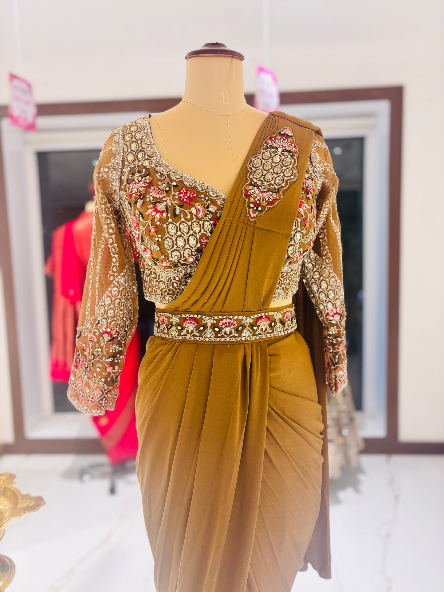 Gold ready made Saree with embroidered blouse.