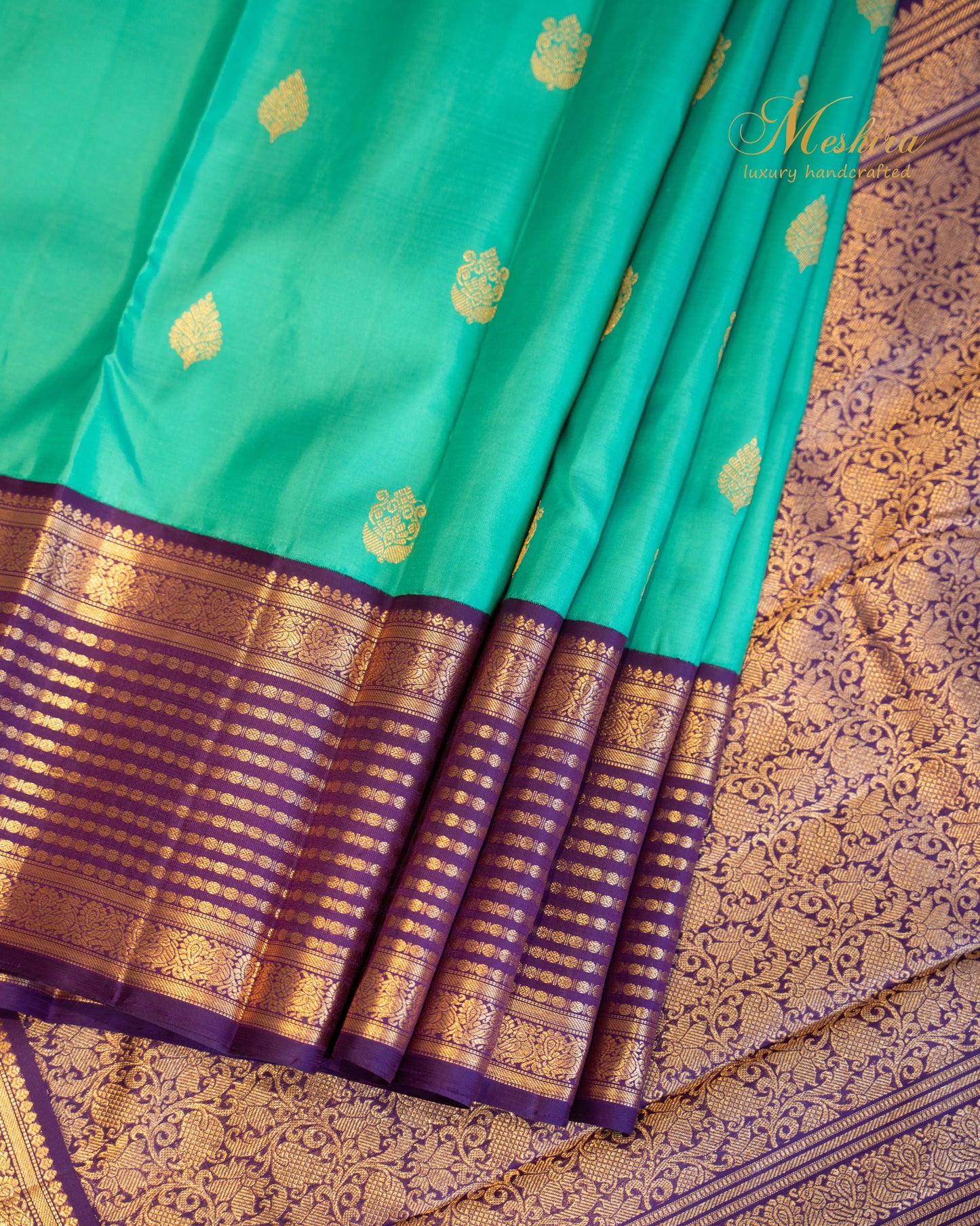 Turquoise blue Kanchivaram silk saree with zari motifs and contrast deep plum border