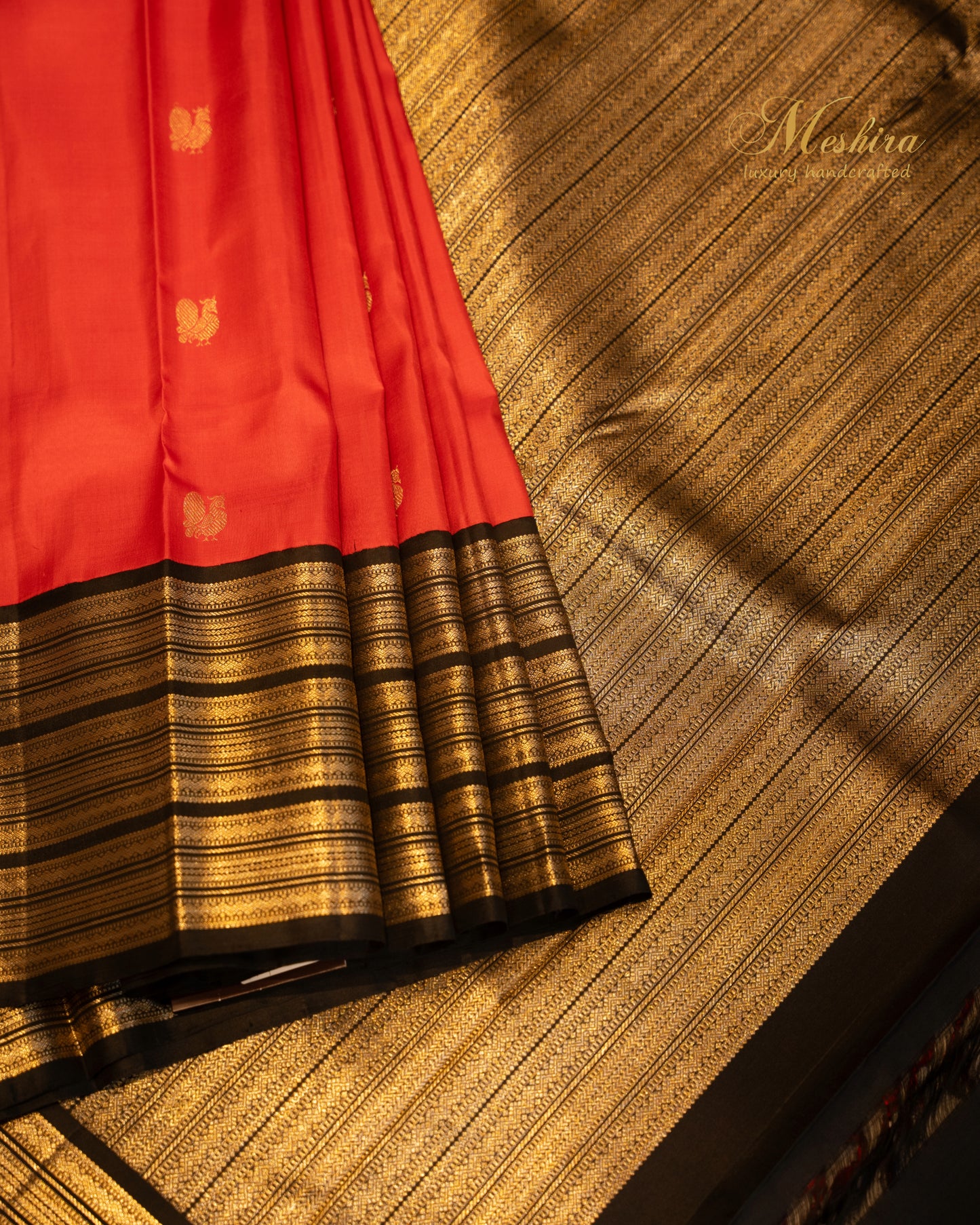 Crimson red Kanchivaram silk saree with black striped silver zari border.