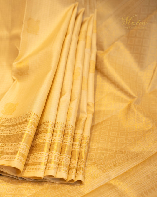 Golden glow Kanchivaram silk saree with Zari buttas.