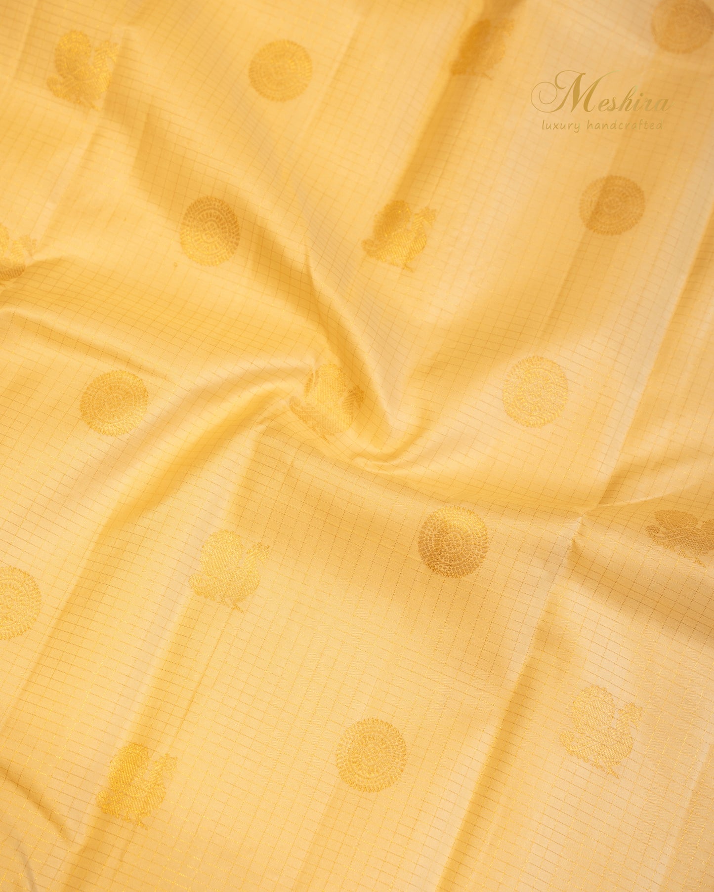Golden glow Kanchivaram silk saree with Zari buttas.