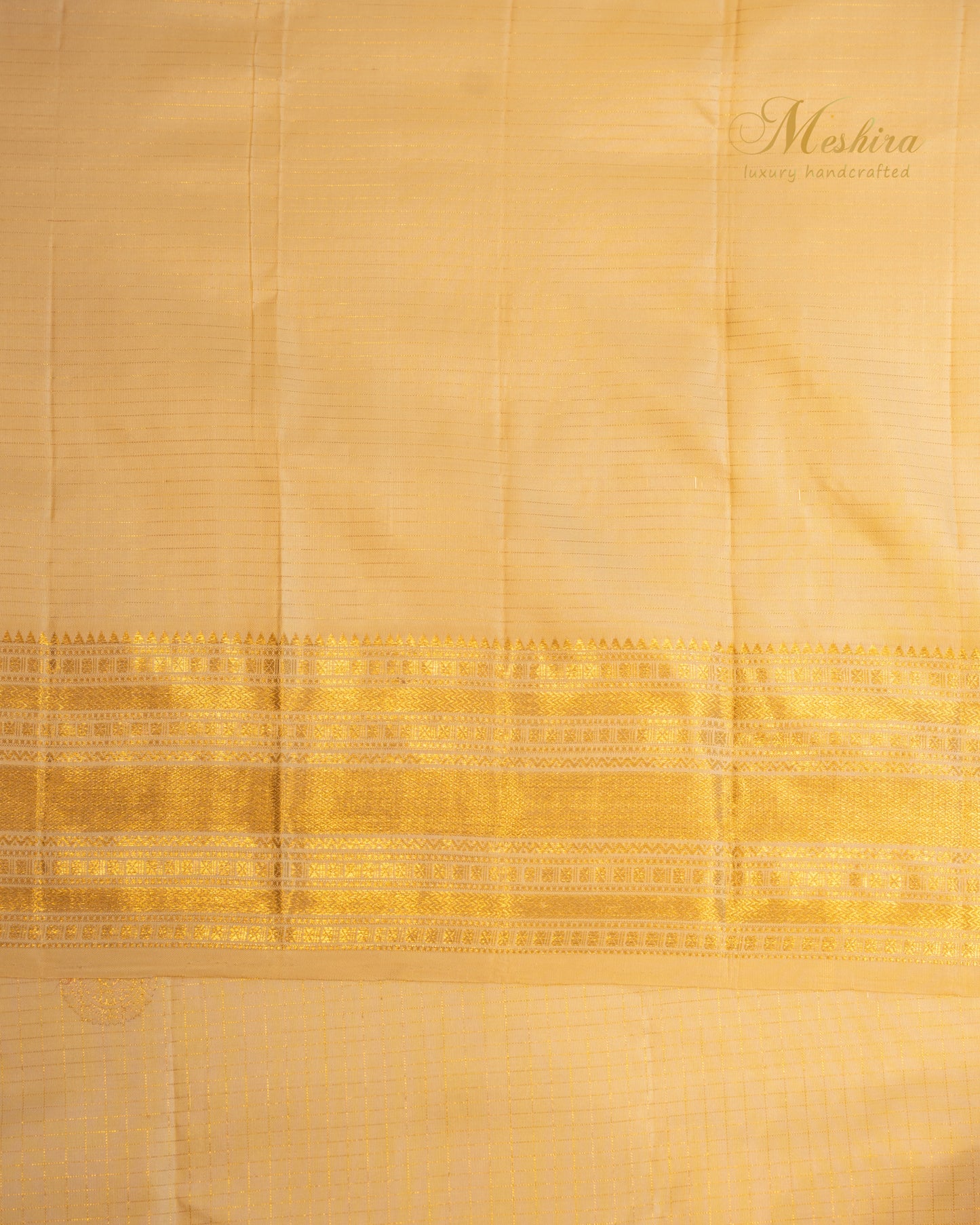 Golden glow Kanchivaram silk saree with Zari buttas.