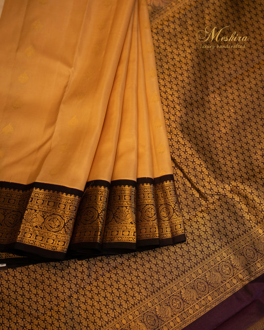 Elegant Kanchivaram silk saree in golden yellow body and rich black border.