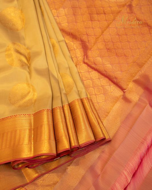 Golden Beige Kanchivaram silk saree with Zari Buttas and Pink Grandeur