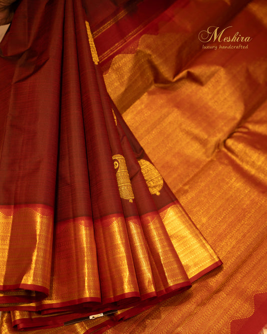 Crimson Kanchivaram silk saree with temple zari and gold pallu