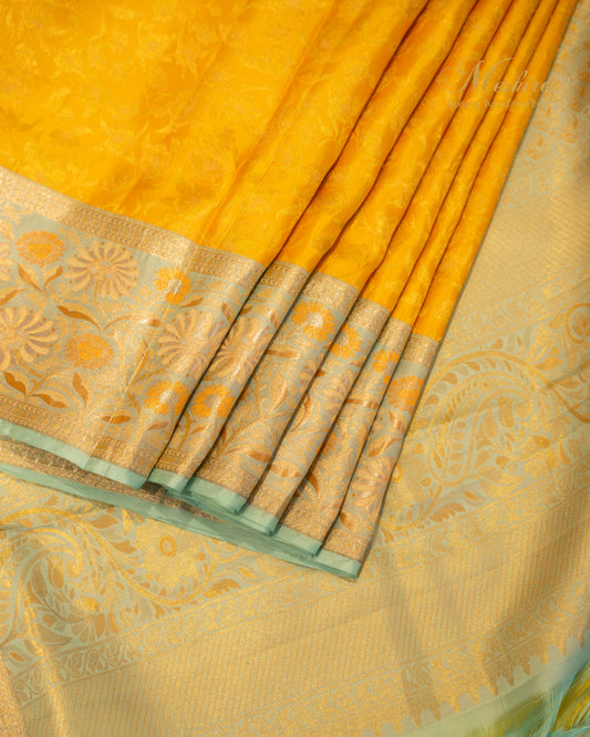 Sunflower yellow Kanchivaram silk saree accented with aqua and gold zari