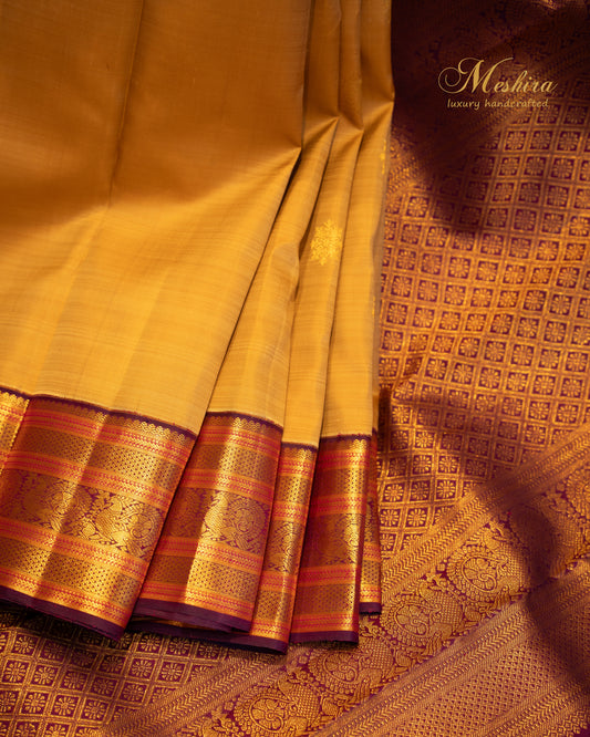 Mustard Beige Kanchivaram silk saree with Maroon Zari border.
