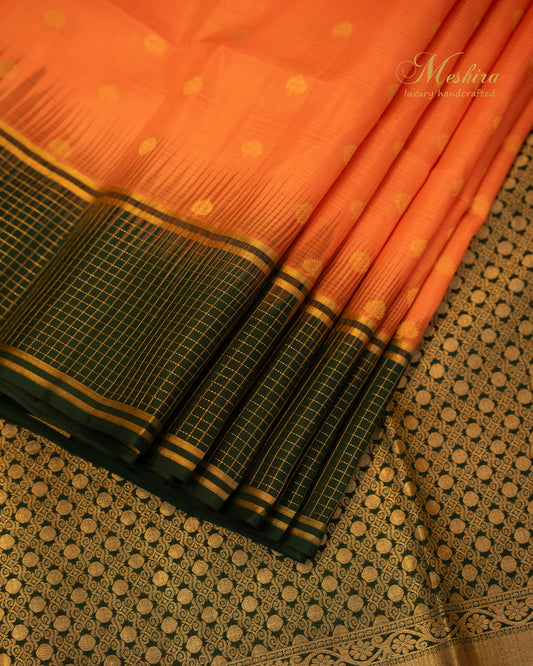 Luminous Orange Kanchivaram Silk saree Draped in Bold green and Gold Zari