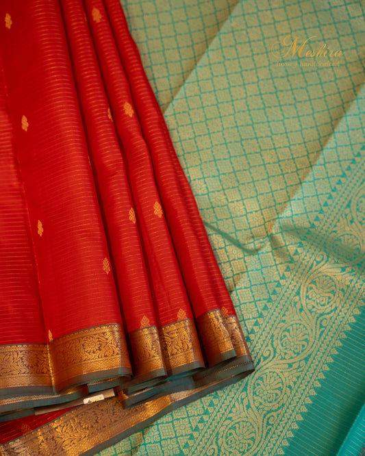 Radiant red Kanchivaram silk saree with turquoise pallu and zari work