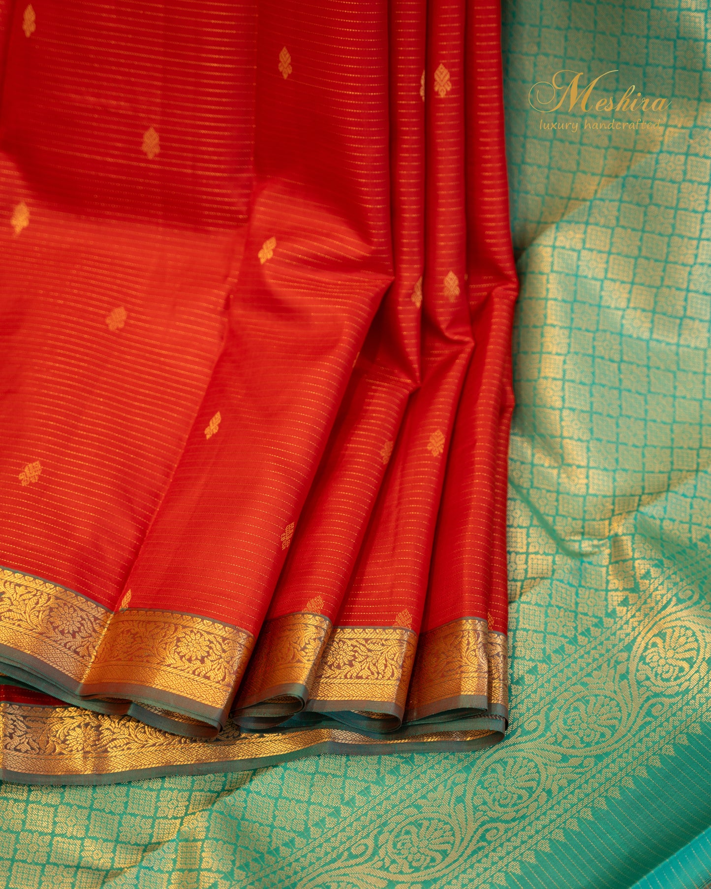 Radiant red Kanchivaram silk saree with turquoise pallu and zari work