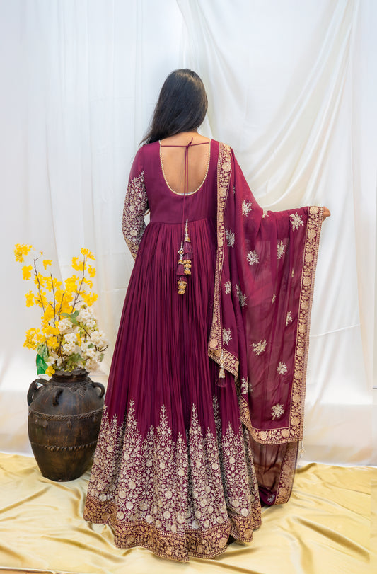A regal maroon Anarkali enriched with intricate golden embroidery