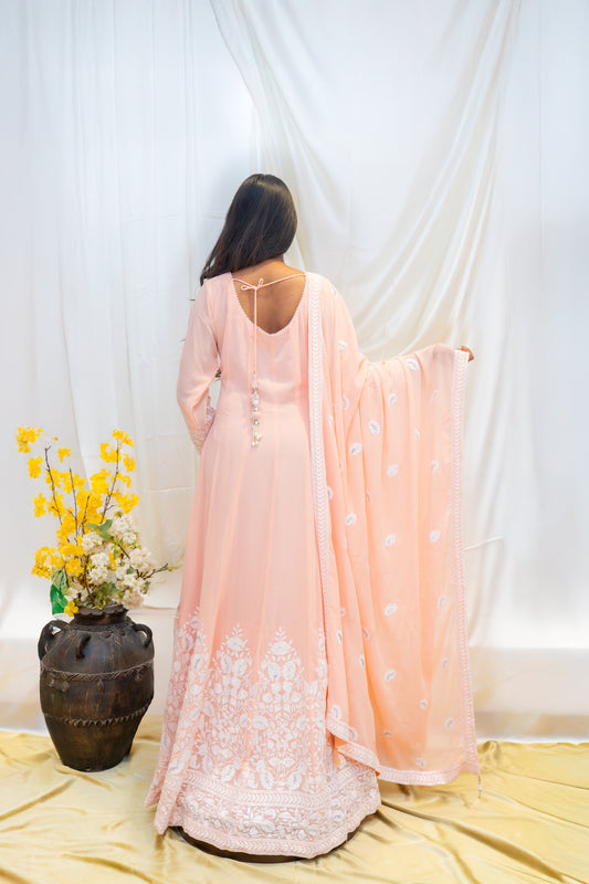 A soft peach Anarkali adorned with delicate white thread embroider
