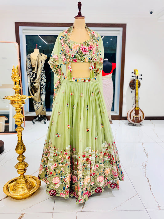 Pastel green lehenga with embroidered blouse and skirt.