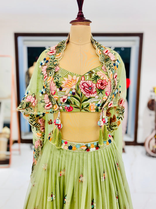 Pastel green lehenga with embroidered blouse and skirt.