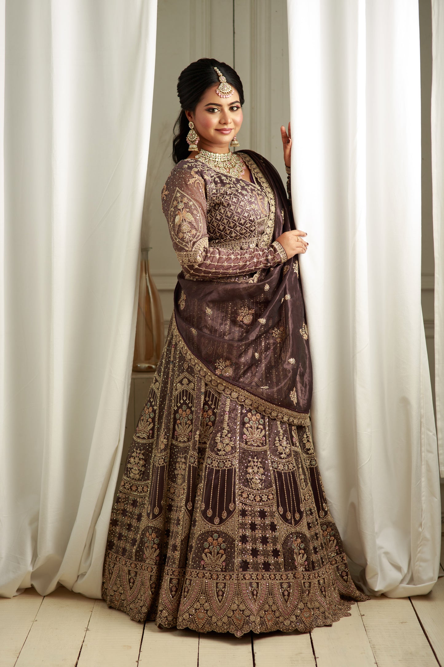Deep charcoal grey lehenga with grand bridal hand work.