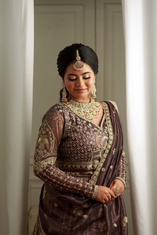 Deep charcoal grey lehenga with grand bridal hand work.