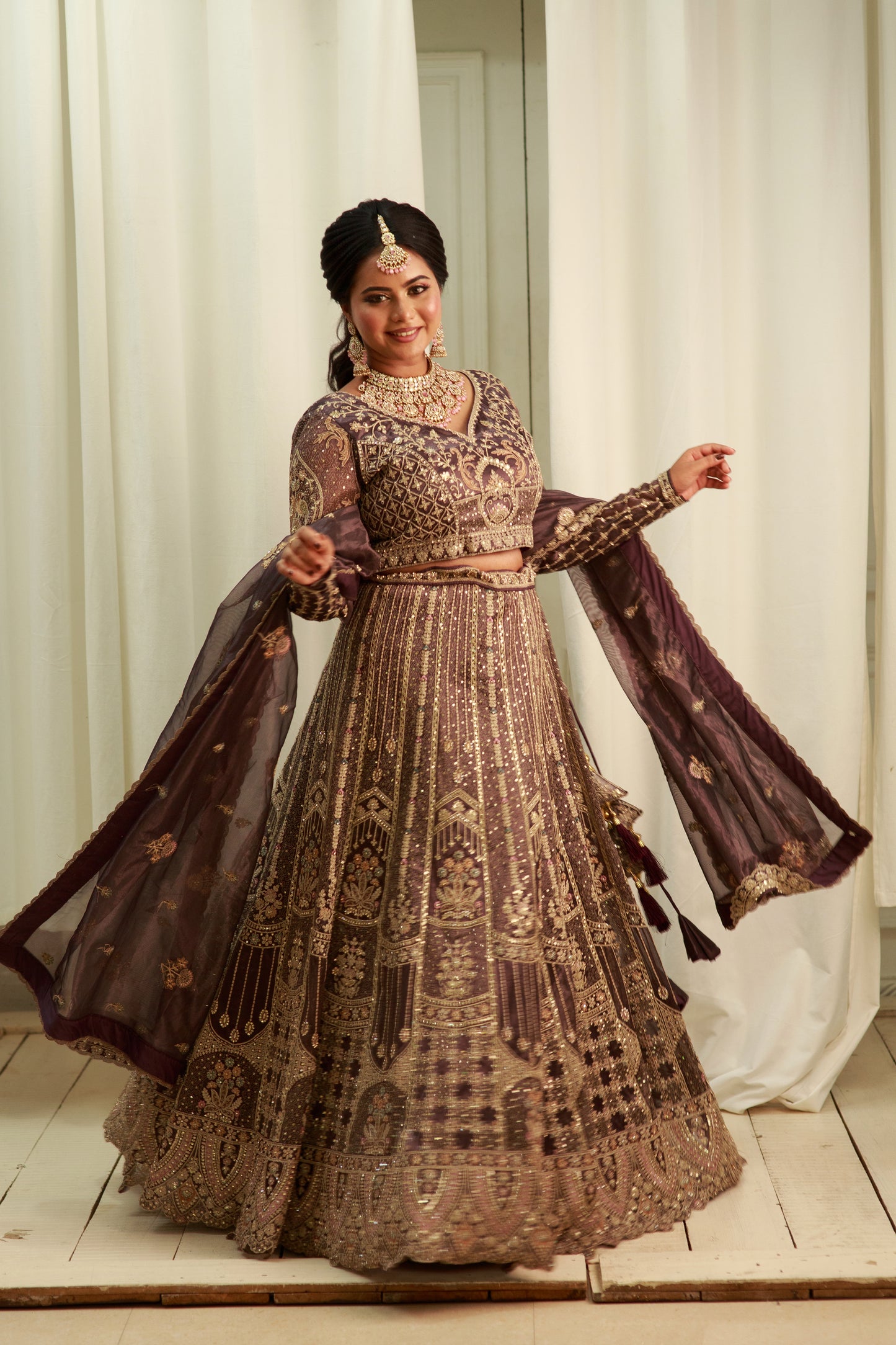 Deep charcoal grey lehenga with grand bridal hand work.