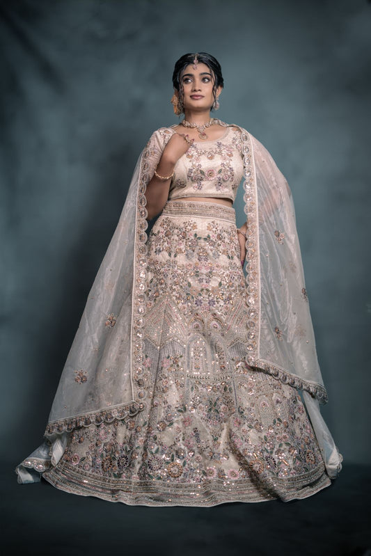Soft pastel ivory embellished lehenga with dupatta and grand blouse.