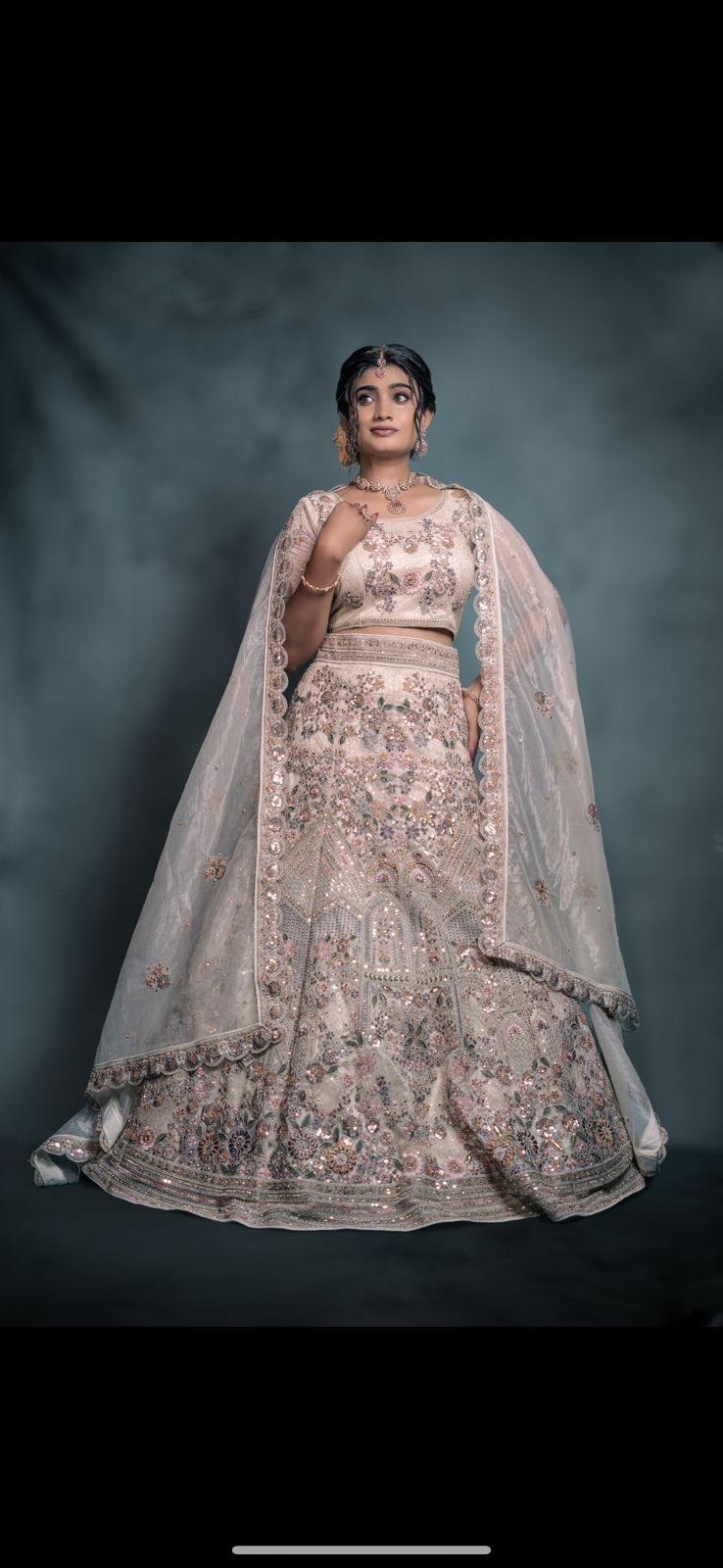 Soft pastel ivory embellished lehenga with dupatta and grand blouse.