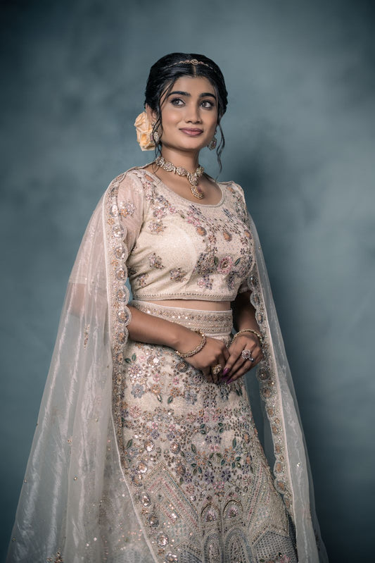 Soft pastel ivory embellished lehenga with dupatta and grand blouse.