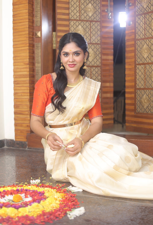 Kerala style Kanchivaram silk saree with golden zari weaves.