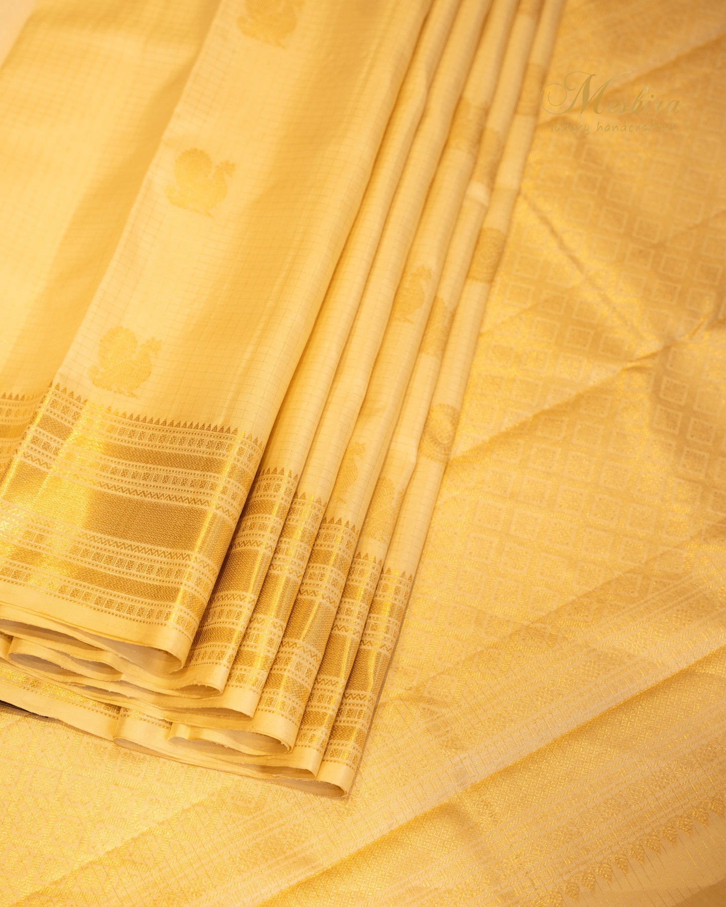 Golden glow Kanchivaram silk saree with Zari buttas.