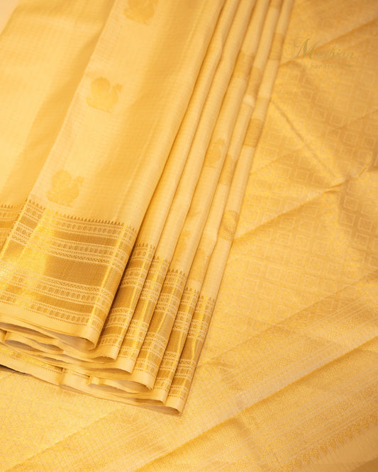 Golden glow Kanchivaram silk saree with Zari buttas.