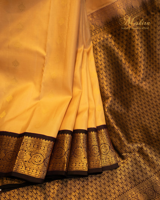 Elegant Kanchivaram silk saree in golden yellow body and rich black border.