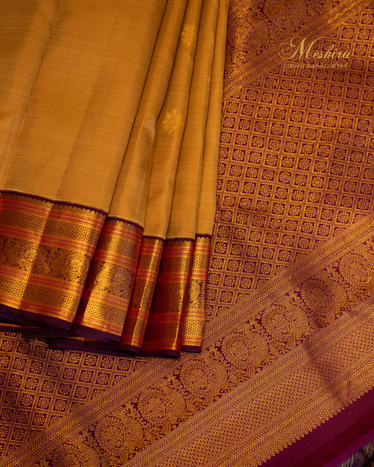 Mustard Beige Kanchivaram silk saree with Maroon Zari border.