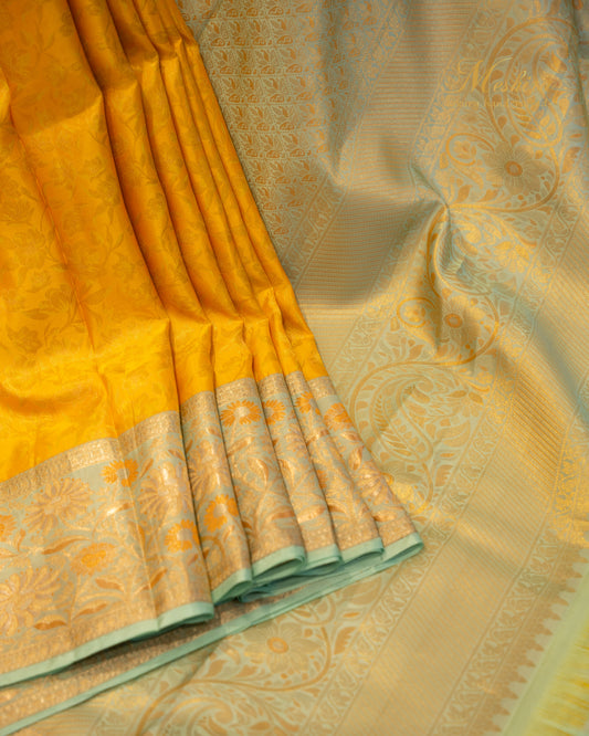 Sunflower yellow Kanchivaram silk saree accented with aqua and gold zari