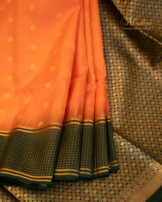 Luminous Orange Kanchivaram Silk saree Draped in Bold green and Gold Zari