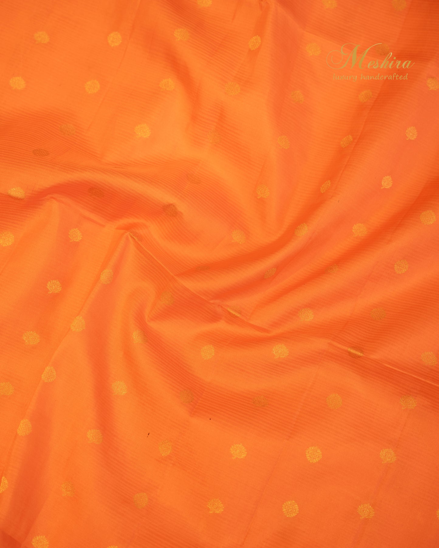 Luminous Orange Kanchivaram Silk saree Draped in Bold green and Gold Zari