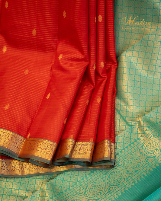 Radiant red Kanchivaram silk saree with turquoise pallu and zari work