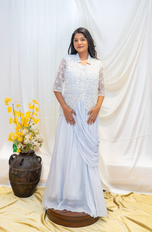 An elegant pastel blue draped gown paired with a delicately embroidered sheer jacket.