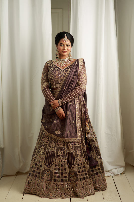 Deep charcoal grey lehenga with grand bridal hand work.