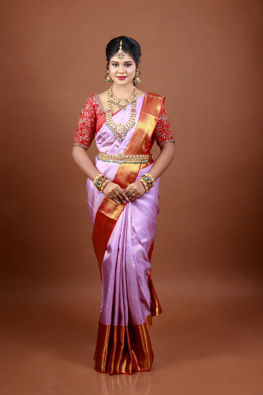 Lavender silk saree with intricate zari and  red colour border