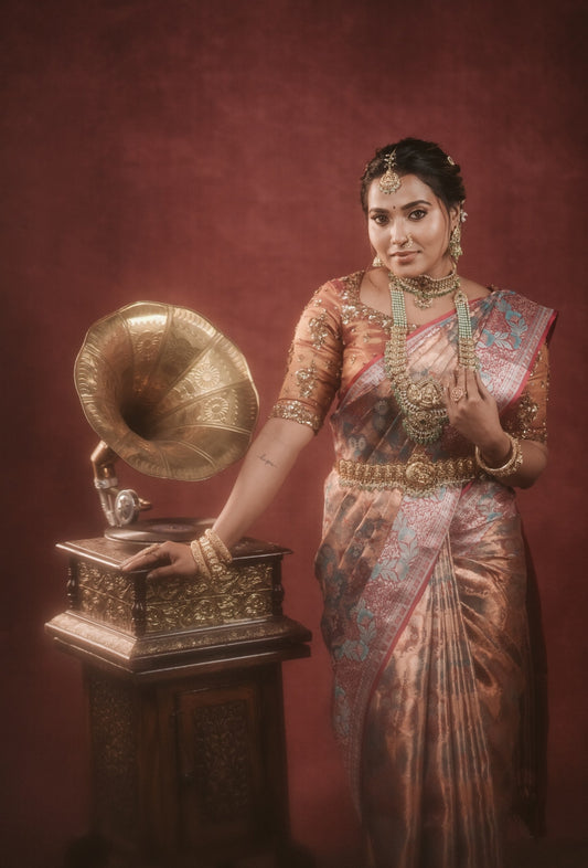 Copper tone silk saree with intricate zari design all over the saree