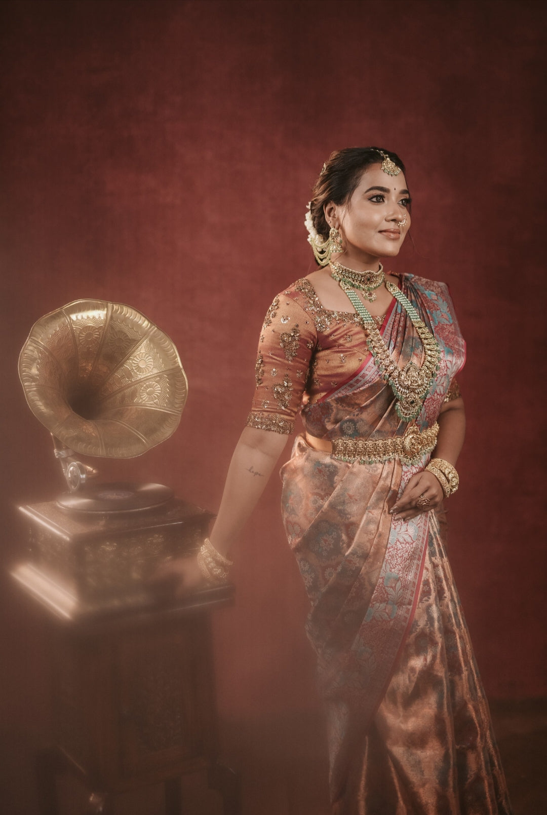 Copper tone silk saree with intricate zari design all over the saree